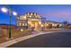Stunning home exterior featuring a unique architectural design and well-lit driveway at dusk at 5790 Aspen Falls Cir, Las Vegas, NV 89149