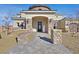 Inviting front entrance with stone pillars, a brick walkway, and elegant outdoor lighting at 5790 Aspen Falls Cir, Las Vegas, NV 89149