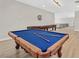 Classic pool table with blue felt and a shuffleboard table in the expansive game room at 5790 Aspen Falls Cir, Las Vegas, NV 89149