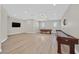 Spacious game room with a pool table, shuffleboard table, and light wood floors at 5790 Aspen Falls Cir, Las Vegas, NV 89149