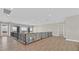 Open hallway with wood floors, iron railing, and scenic views from the windows at 5790 Aspen Falls Cir, Las Vegas, NV 89149