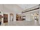 Expansive living room with high ceilings, a stone fireplace, and an open layout into the kitchen at 5790 Aspen Falls Cir, Las Vegas, NV 89149