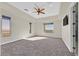 Bright main bedroom features tray ceilings, a ceiling fan, and multiple windows showcasing outdoor views at 5790 Aspen Falls Cir, Las Vegas, NV 89149