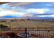 Scenic mountain view from the balcony featuring a custom fire pit, desert landscape, and homes in the distance at 5790 Aspen Falls Cir, Las Vegas, NV 89149