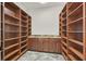 Walk-in pantry featuring custom shelving and granite countertops at 5790 Aspen Falls Cir, Las Vegas, NV 89149