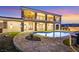 Backyard view of the amazing pool and home with a grand balcony overlooking a scenic landscape at 5790 Aspen Falls Cir, Las Vegas, NV 89149