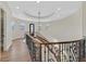 Elegant curved staircase with decorative iron railing and wood steps leads to the upper level at 5790 Aspen Falls Cir, Las Vegas, NV 89149