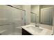 Modern bathroom featuring tiled walk-in shower, modern sink, and sleek fixtures at 7308 Davenbury St, Las Vegas, NV 89113