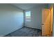Cozy bedroom with neutral walls, carpet flooring, and a window providing natural light at 7308 Davenbury St, Las Vegas, NV 89113