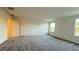 Inviting bonus room featuring neutral carpet, white walls, and natural light from two windows at 7308 Davenbury St, Las Vegas, NV 89113