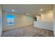 Upstairs bonus room features neutral carpet, white walls, and natural light from two windows at 7308 Davenbury St, Las Vegas, NV 89113