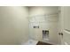 Efficient laundry room with hookups, storage, and space for washer and dryer at 7308 Davenbury St, Las Vegas, NV 89113