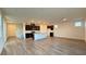 Bright open-concept living space with modern floors and a spacious kitchen featuring a central island at 7308 Davenbury St, Las Vegas, NV 89113