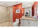 Bathroom with walk-in shower and red accent wall at 9101 Alta Dr # 505, Las Vegas, NV 89145