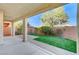 Covered patio with artificial grass and block wall at 9306 Goldenbush Ct, Las Vegas, NV 89148