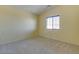 Bright bedroom with carpeted floors and window at 9893 Cove Haven Ct, Las Vegas, NV 89178