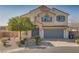 Two-story house with gray garage door and landscaping at 9893 Cove Haven Ct, Las Vegas, NV 89178