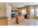 Kitchen with island, wood cabinets, and granite countertops at 9893 Cove Haven Ct, Las Vegas, NV 89178