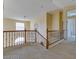 Spacious upper hallway with wood railing and plush carpeting at 9893 Cove Haven Ct, Las Vegas, NV 89178