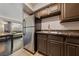 Kitchen features stainless steel appliances and dark brown cabinets at 100 S Crestline Dr # 10, Las Vegas, NV 89107