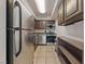 Stainless steel appliances and dark wood cabinets in this galley kitchen at 100 S Crestline Dr # 10, Las Vegas, NV 89107