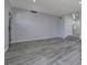 Living room with gray laminate floors, neutral walls and entryway at 10701 Penfolds St, Las Vegas, NV 89183