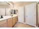 Double vanity bathroom with large mirrors and linen closet at 1336 Allegheny Moon Ter # 103, Henderson, NV 89002