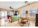 Dining area with round table, chairs, and view of the living room at 1336 Allegheny Moon Ter # 103, Henderson, NV 89002