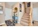 Inviting entryway with staircase, decorative console table, and patterned rug at 1336 Allegheny Moon Ter # 103, Henderson, NV 89002