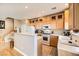 Kitchen with light wood cabinets, white appliances, and granite countertops at 1336 Allegheny Moon Ter # 103, Henderson, NV 89002