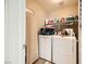Convenient laundry room with washer, dryer, and storage at 1336 Allegheny Moon Ter # 103, Henderson, NV 89002