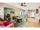 Living room with green sofa, ceiling fan, and access to backyard at 1336 Allegheny Moon Ter # 103, Henderson, NV 89002