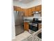 Modern kitchen featuring stainless steel appliances and wood cabinets at 1726 N Jones Blvd, Las Vegas, NV 89108