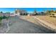 Large backyard with gravel, stone pathway, and mature trees at 1964 Westwind Rd, Las Vegas, NV 89146