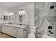 Updated bathroom with double vanity, granite countertops and marble tile at 1964 Westwind Rd, Las Vegas, NV 89146