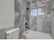 Modern bathroom with gray marble-look tiles and a bathtub at 1964 Westwind Rd, Las Vegas, NV 89146