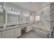 Elegant bathroom with double vanity, soaking tub, and marble tile at 1964 Westwind Rd, Las Vegas, NV 89146