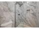 Clean bathroom with a walk-in shower and marble-style tile at 1964 Westwind Rd, Las Vegas, NV 89146