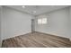 Well-lit bedroom with wood-look floors and access to a bathroom at 1964 Westwind Rd, Las Vegas, NV 89146