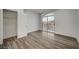 Bright bedroom with wood-look floors, a large closet, and access to a private balcony at 1964 Westwind Rd, Las Vegas, NV 89146
