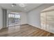 Bright bedroom with wood-look floors and sliding glass door to balcony at 1964 Westwind Rd, Las Vegas, NV 89146