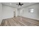 Bright bedroom with wood-look floors, ceiling fan and access to bathroom and closet at 1964 Westwind Rd, Las Vegas, NV 89146