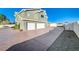 Three-car garage with a large concrete driveway at 1964 Westwind Rd, Las Vegas, NV 89146
