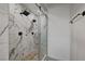 Spa-like shower with marble walls, pebble floor, and dual shower heads at 1964 Westwind Rd, Las Vegas, NV 89146