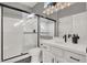 Modern bathroom with white vanity and glass shower at 2073 Desert Woods Dr, Henderson, NV 89012