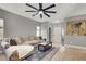 Spacious living room with L-shaped sofa and ceiling fan at 2073 Desert Woods Dr, Henderson, NV 89012