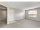 Spacious living room with gray carpeting and access to other rooms at 2300 E Silverado Ranch Blvd # 1002, Las Vegas, NV 89183