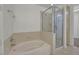 Bathroom featuring a bathtub with shower fixture and adjacent glass-enclosed shower at 26 E Serene Ave # 124, Las Vegas, NV 89123