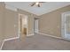 Inviting bedroom with plush carpeting, ceiling fan, ensuite bathroom, and access to the outside at 26 E Serene Ave # 124, Las Vegas, NV 89123
