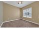 Bedroom featuring a ceiling fan and ample natural light through large windows at 26 E Serene Ave # 124, Las Vegas, NV 89123